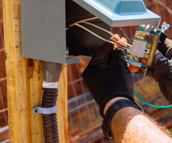 Technician,Works,On,Outlets,Connecting,Wires,To,An,Electrical,Panel
