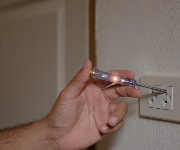 Close-up,Photo,Of,Hand,Holding,Screwdrivers,Mains,Tester,For,Measuring