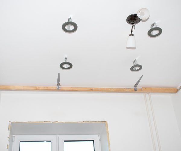 Installation of LED lamps on a stretch ceiling.