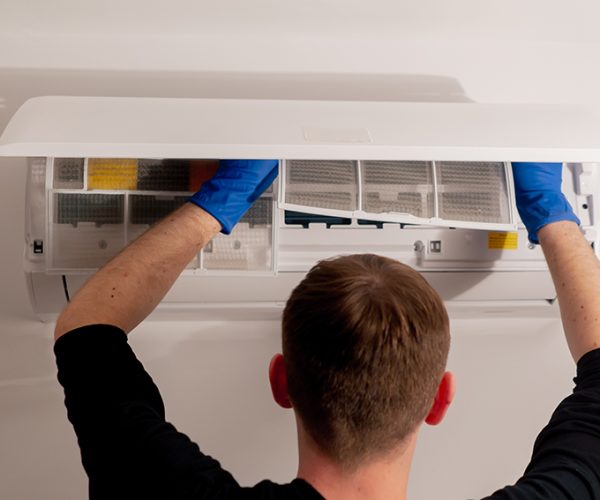 close up in the apartment the cleaner is cleaning the filters in the air conditioner filling the cooler