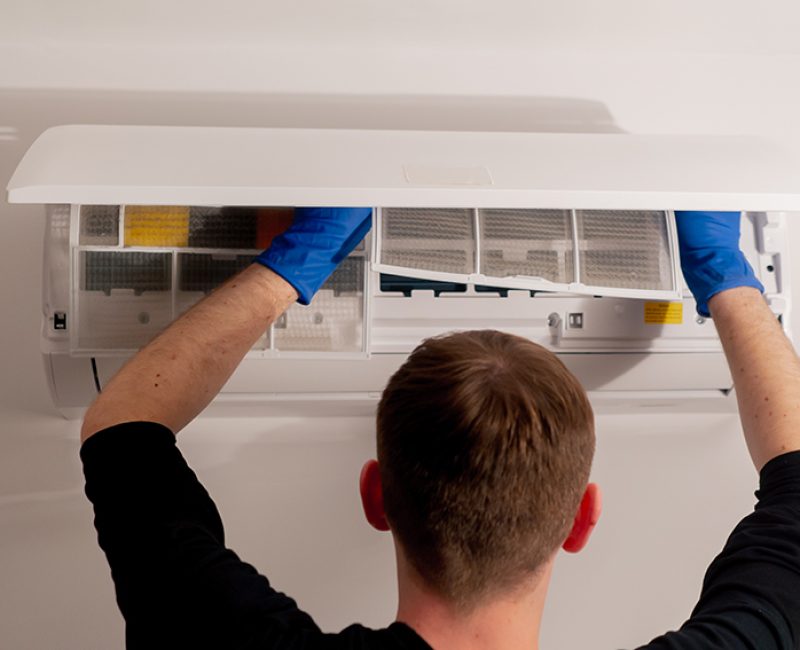 close up in the apartment the cleaner is cleaning the filters in the air conditioner filling the cooler
